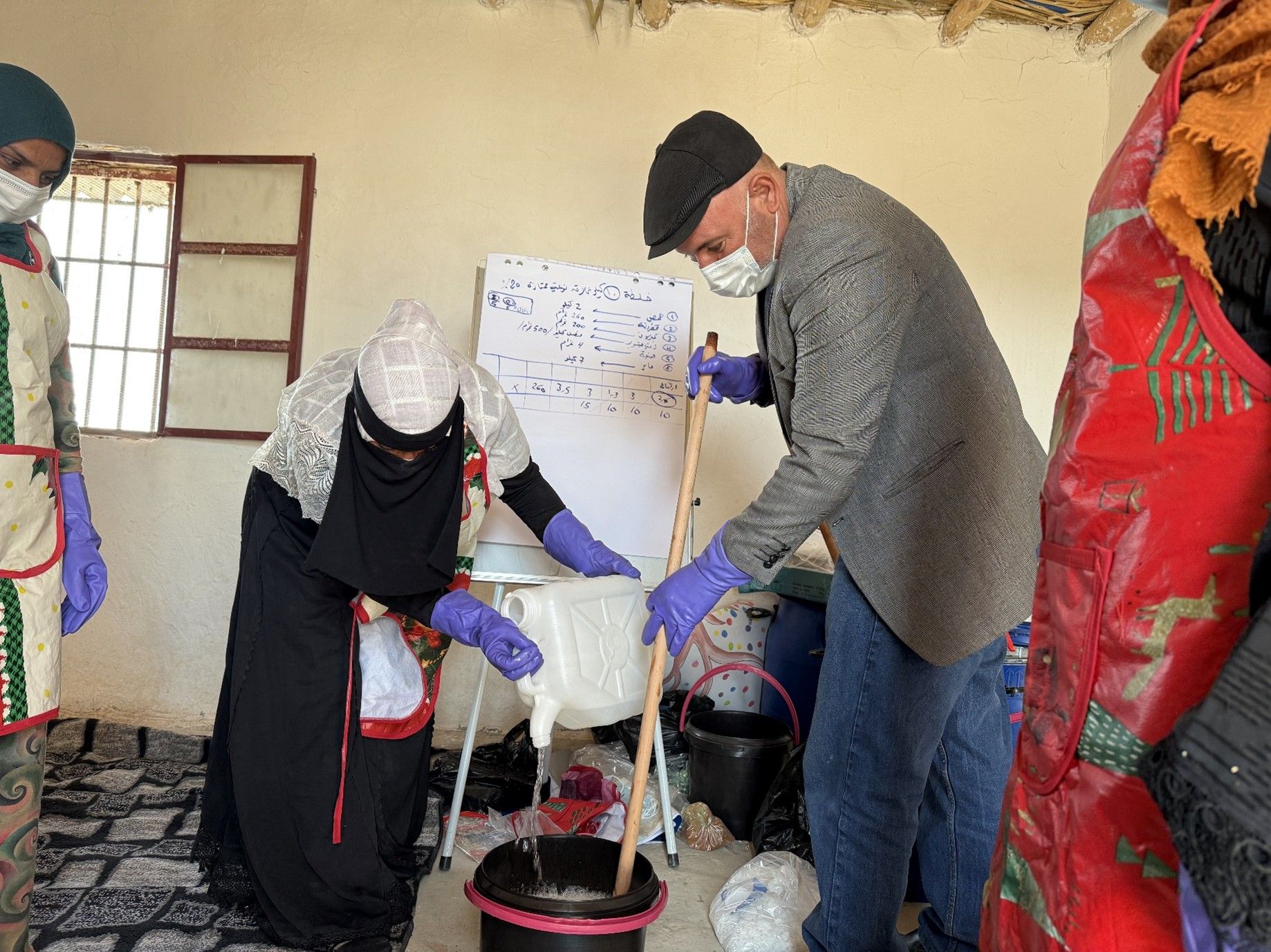 Right holder and trainer during the soap making
