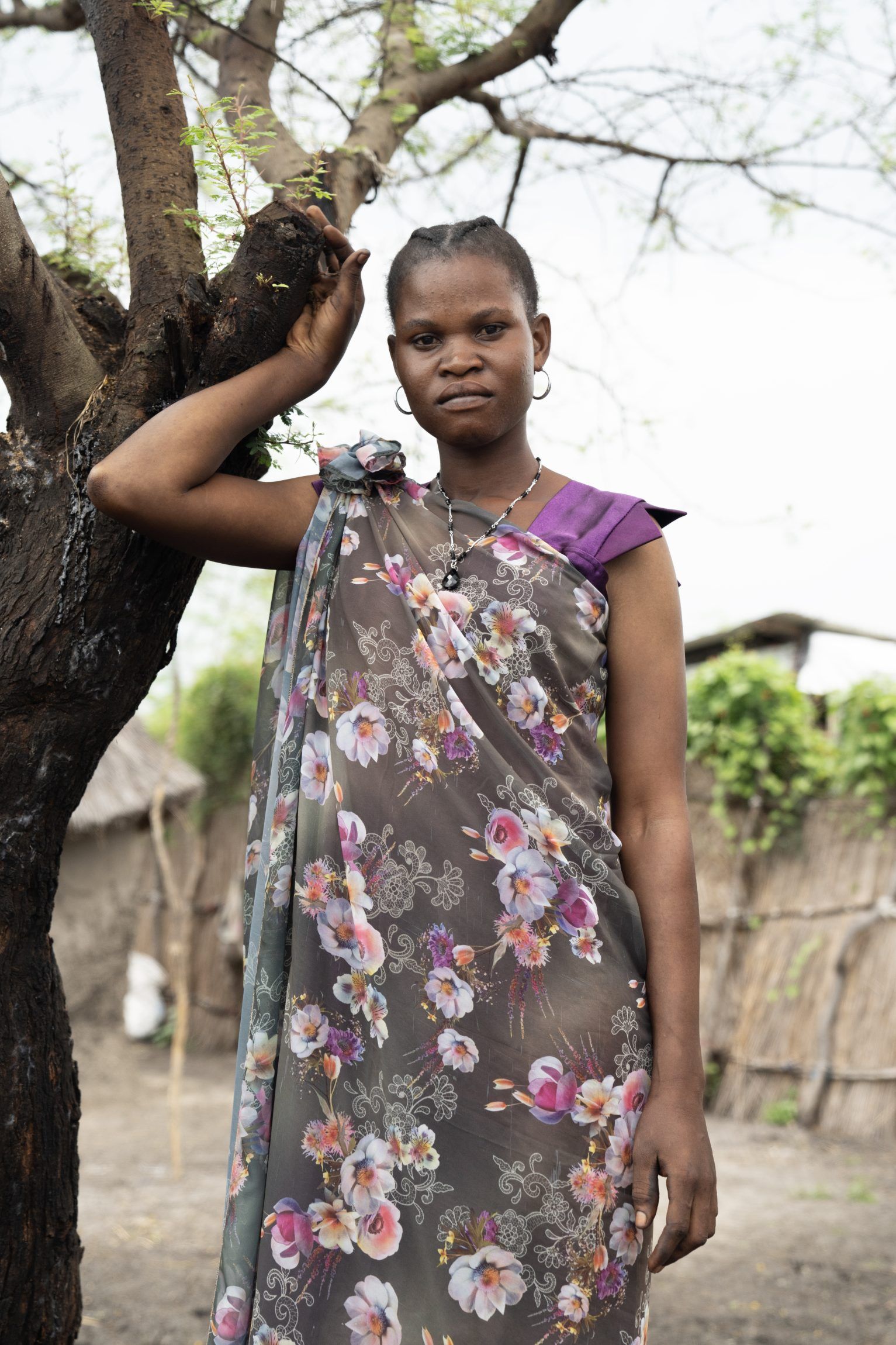 Portræt af kvinde op ad træ.